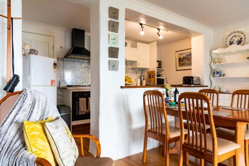 a kitchen and dining room with a table and chairs at Million Dollar Views in Hobart
