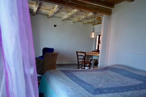 a bedroom with a bed and a table with a chair at Dream vacation on the lake in Brissago