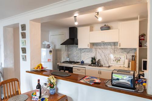 a kitchen with white cabinets and a counter top at Million Dollar Views in Hobart