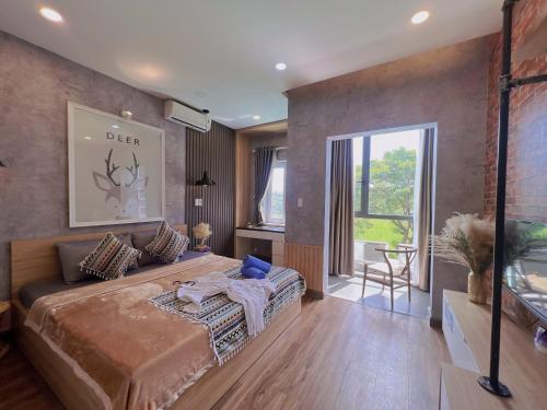 a bedroom with a large bed and a large window at MIS HOSTEL Cần Thơ in Can Tho