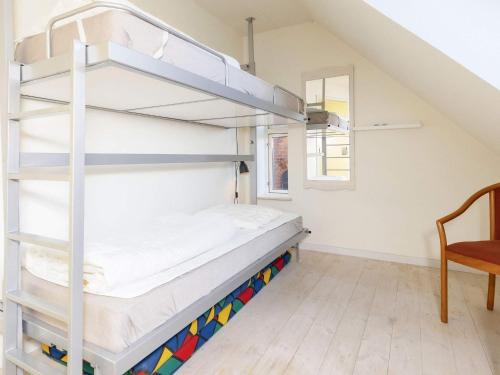 a bunk bed in a room with a staircase at 20 person holiday home in Sæby-By Traum in Sæby