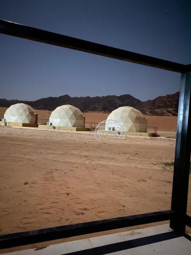 a view of three domes in the desert at Sandy Camp Wadi Rum in Wadi Rum