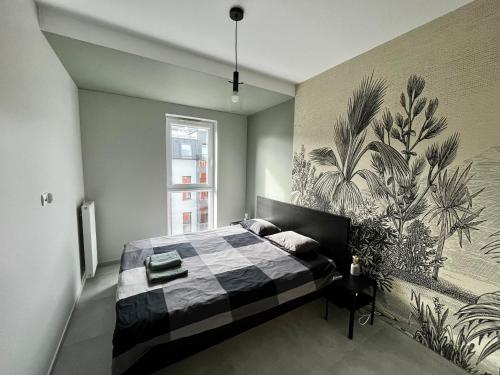 a bedroom with a bed with a mural on the wall at City Center Apartments z parkingiem in Bydgoszcz