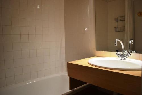 une salle de bain avec un lavabo et une baignoire dans l'établissement T2 six couchages, exposé sud, sur les pistes, à Risoul