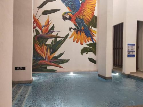 a mural of a parrot on a wall in a building at Singgahsini Guesthouse Putrajaya in Putrajaya