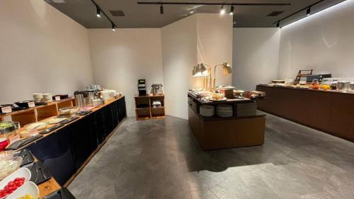 a room with a buffet line with food on display at EN HOTEL Hiroshima in Hiroshima