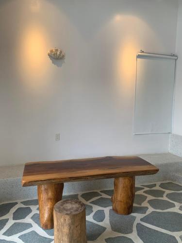 a wooden bench sitting in a room next to a wall at Santorini Villa Cam Ranh in Cam Ranh