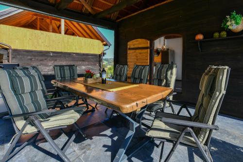 a wooden table and chairs on a patio at Holiday Home BIBA With Heated Outdoor Pool in Gornja Stubica