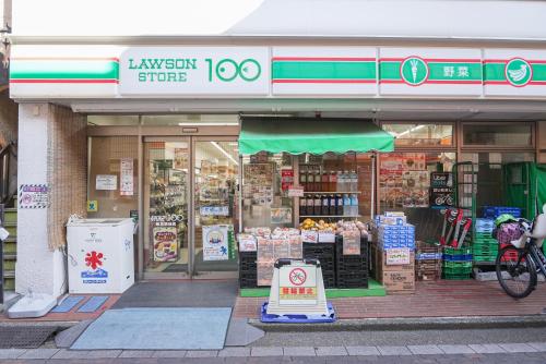 a store front of a store with a bike in front at Lodging Tokyo Shibamata in Tokyo