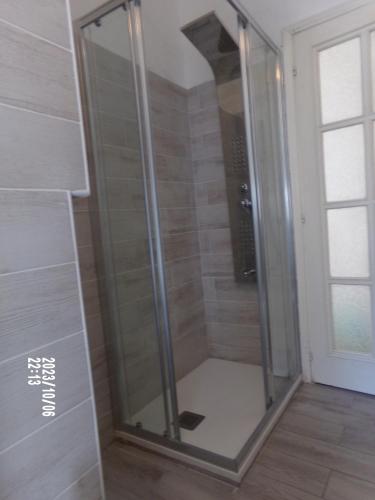 a shower with a glass door in a bathroom at Appartamento di Olga in Lecco