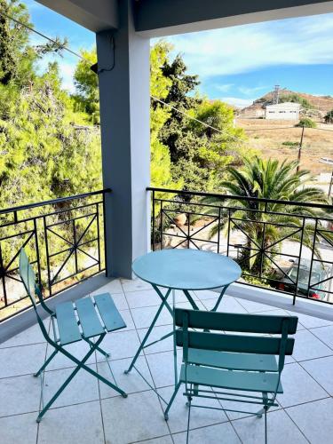 a table and two chairs on a balcony with a view at Lemnos Urban Escape in Myrina