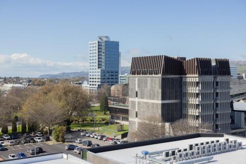 a city skyline with tall buildings and a parking lot at Luxury 2 Bedroom CBD Apartment with Free Parking in Christchurch