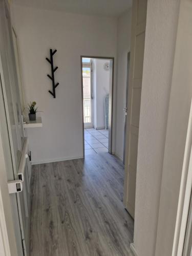 an empty hallway with white walls and wood floors at VringsVeedel in Cologne