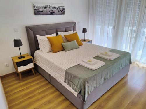 a bedroom with a large bed with two plates on it at Apartment in the historic center of Porto in Porto