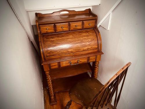 a wooden dresser in the corner of a room at King Bed - 5 Min to MOA - 75 & 65' HDTV - Ping Pong in Richfield