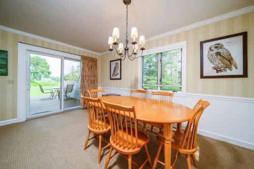 a dining room with a wooden table and chairs at Stoweflake Mountain Resort & Spa in Stowe