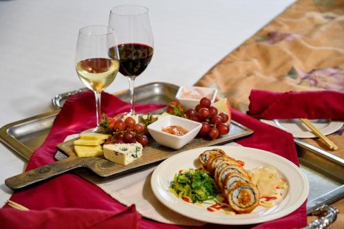 a tray with a plate of food and two glasses of wine at Stoweflake Mountain Resort & Spa in Stowe