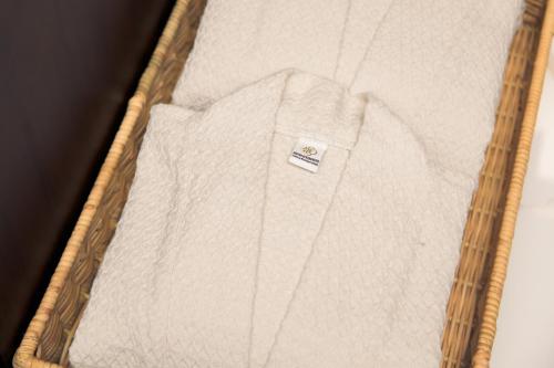 a white shirt in a box with a tag on it at CHINO@NIMMAN Luxury Boutique Hotel in Chiang Mai
