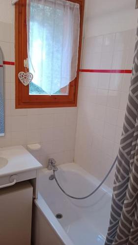 a bathroom with a shower and a sink and a tub at Superbe appartement à Valfréjus in Valfréjus