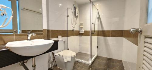 a bathroom with a sink and a toilet and a shower at Issara Patong Beach in Patong Beach