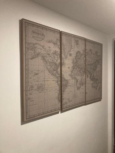 a map of the world hanging on a wall at Brignole Rooms in Genova