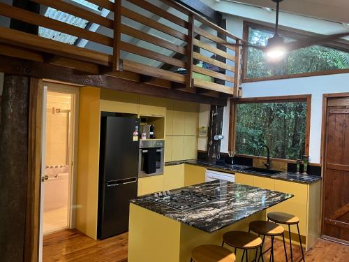 eine Küche mit einer schwarzen und gelben Arbeitsplatte in der Unterkunft Figtree Getaway in Malanda