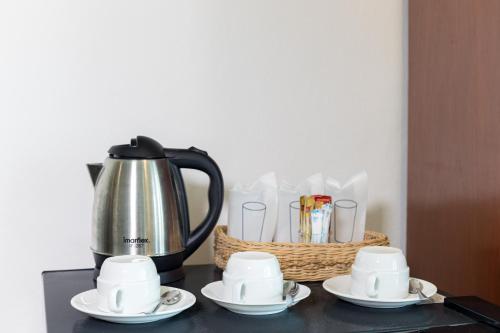 a black table with a tea pot and cups and a basket at Bevans Place Karon in Karon Beach