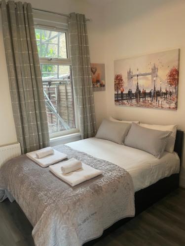 a bedroom with a bed with two towels on it at Amazing Studio Room 1 - East Ham/East London in London