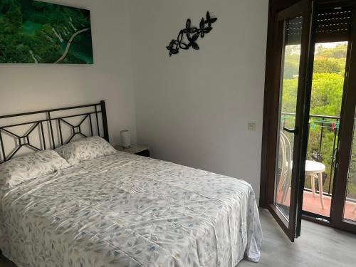 a bedroom with a bed and a view of a balcony at Mansion Alhamar in Sitio de Calahonda