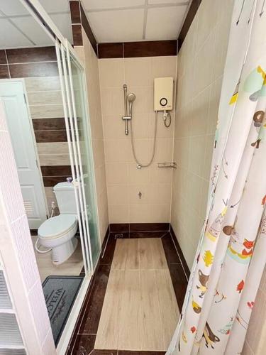 a bathroom with a shower with a toilet and a shower curtain at KhaoYai Treescape Retreat คอนโดบ้านชลธารเขาใหญ่ 2 ห้องนอน 2ห้องน้ำ 88ตารางเมตร ถนนธนะรัชต์ in Ban Tha Maprang