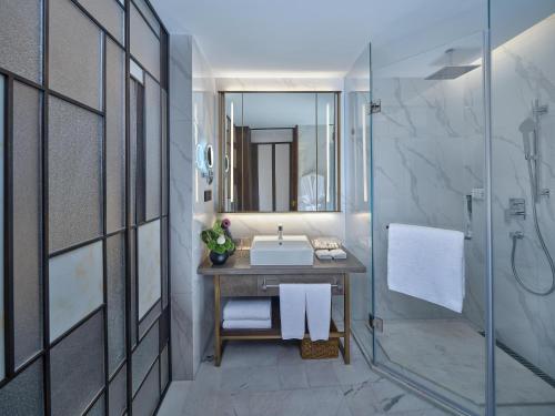a bathroom with a sink and a shower at Jin Jiang International Hotel Taicang in Taicang