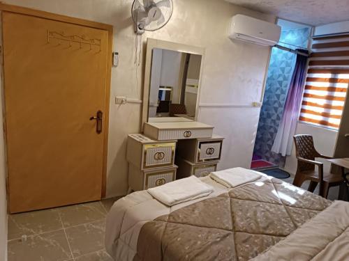 a bedroom with a bed and a sink and a mirror at hostel ـ Karak dream in Kerak