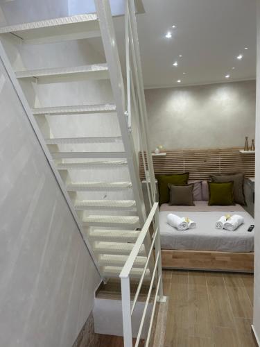 a bedroom with a bed and a staircase at La Casa delle Tradizioni in Bari