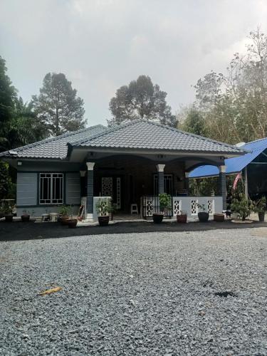 a house on the side of the road at Cp homestay in Batu Kurau