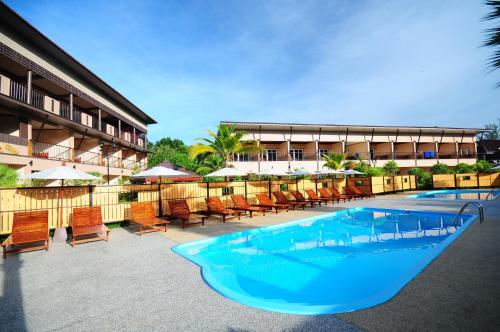 a large swimming pool with chairs and a building at Maleedee Bay Resort in Ao Nang Beach