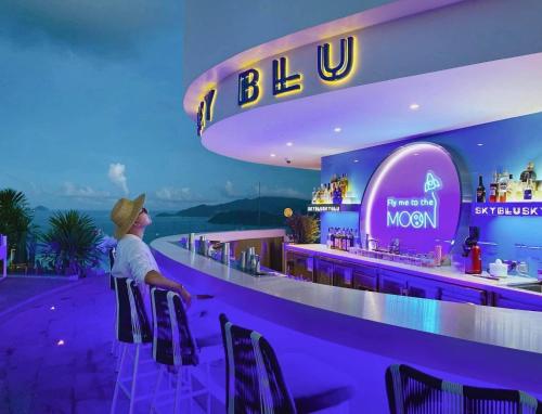 a woman standing at a bar in a restaurant at JK.Boutique Oceanfront Panorama Residence in Nha Trang