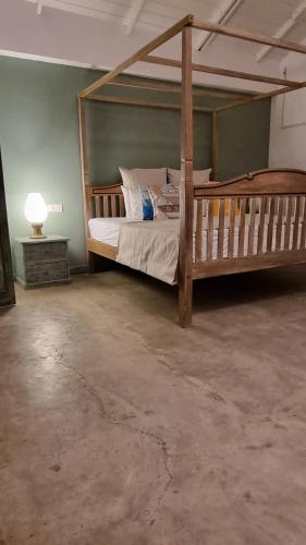 a bedroom with a large wooden bed in a room at Nagenahira Beach Villa in Nilaveli