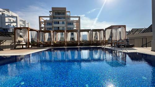 a large blue swimming pool on top of a building at Olivia Palm Hotel in Kyrenia