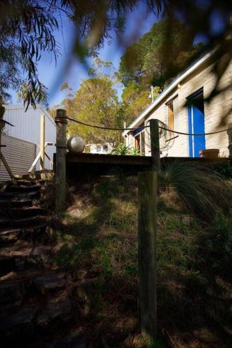 a wooden fence in front of a house at Killora Coastal Shack in Killora