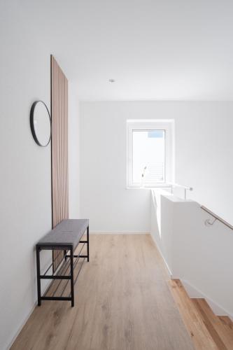 a chair in an empty room with a window at Neusaniertes 3Familienhaus am Bahnhof Wyhlen 7Min von Basel CH in Grenzach-Wyhlen