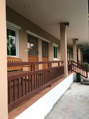 a porch of a house with wooden railing at Sripiamsuk Resort Bangkok in Pathum Thani