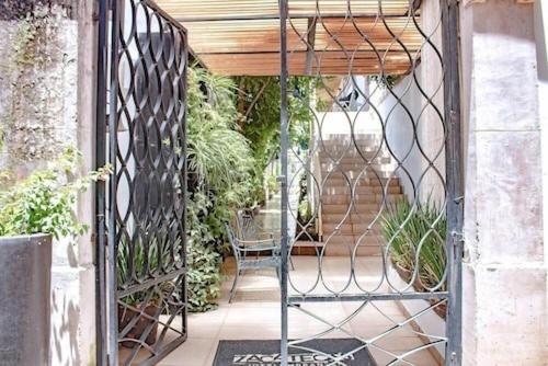 an entrance to a garden with a metal gate at Mansión Aréchiga in Zacatecas