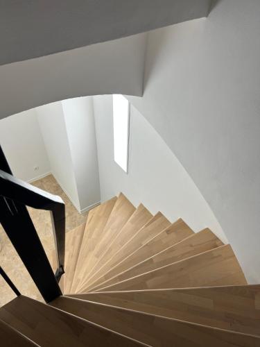 a wooden staircase in a room with a white ceiling at Apartment in Stadtzentrum Oelsnitz in Oelsnitz