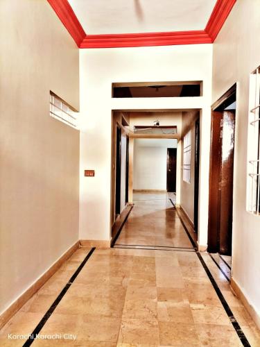 an empty hallway with white walls and a red ceiling at GULSHAN PALACE Near AghaKhanHospital ExpoCenter Airport in Karachi