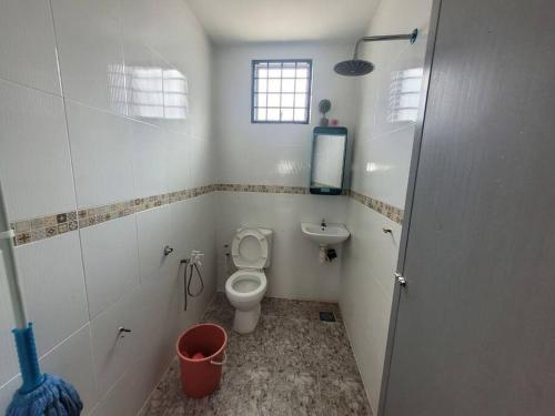 a bathroom with a toilet and a sink at Homestay Melor Serendah in Serendah
