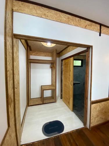 a view of the inside of a tiny house with the door open at Sunrise House in Ko Yao Noi