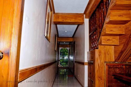 un corridoio di una casa con scala e vetrata colorata di Twin Room in Casa de Piedra Pension House 