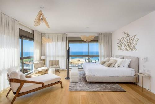 a white bedroom with a bed and a view of the ocean at #Breathtaking 4BR/3BA Duplex Seafront in Tel Aviv