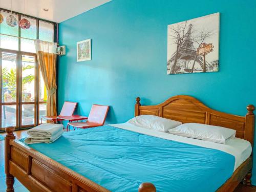 Dormitorio azul con cama y pared azul en บ้านพักสิริ มุกดาหาร (Baan Siri Mukdahan) en Ban Muang Ba