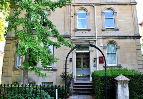 an old building with a gate in front of it at Victoria Square Hotel Clifton Village in Bristol